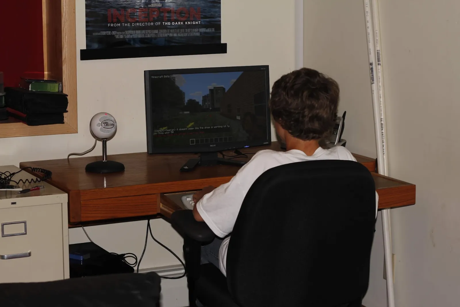 funkystudios at a desk, seen from behind, playing Minecraft Beta 1.8.1 on TerraScape, with a microphone beside the monitor