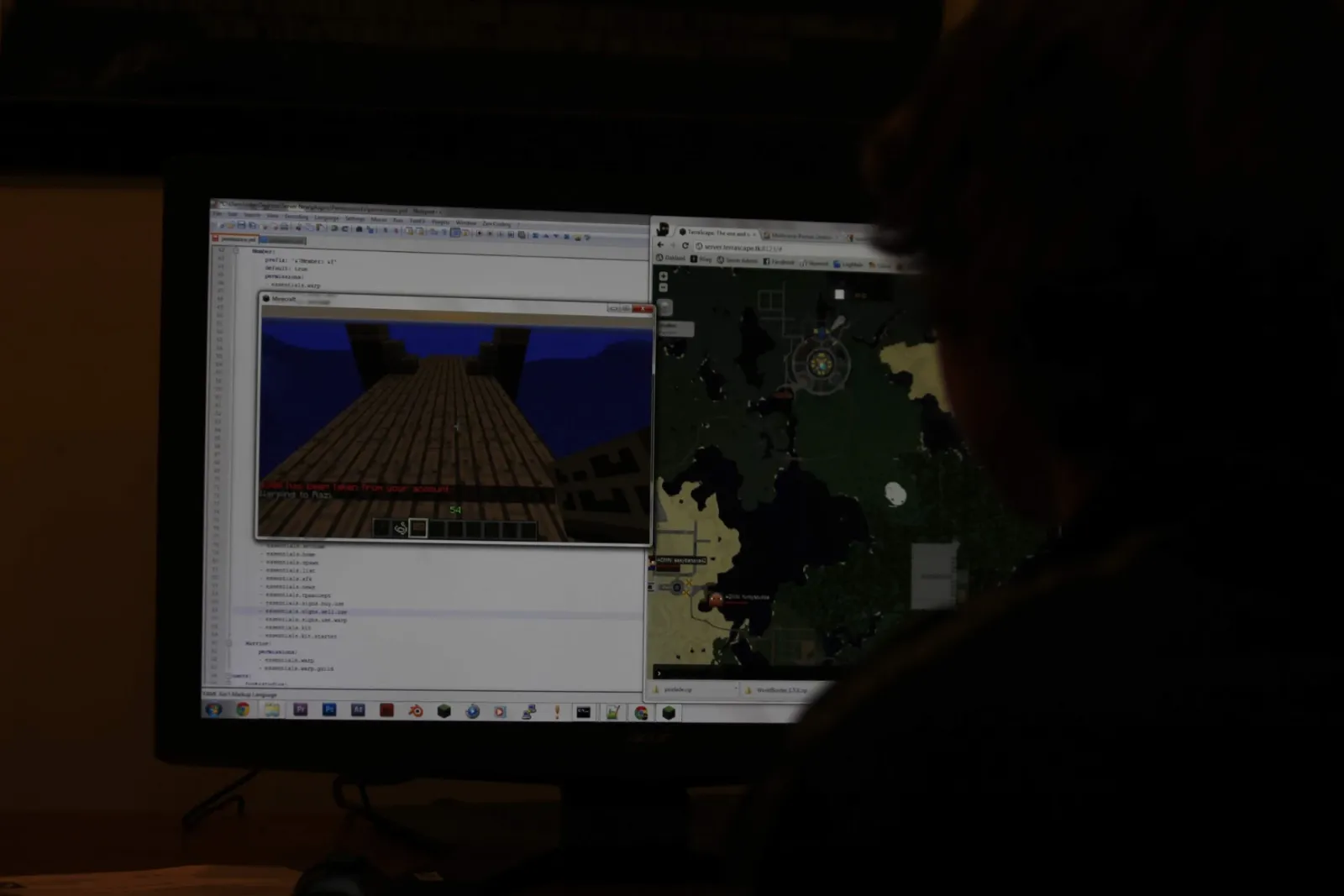 A dim monitor showing a permissions file being edited, Minecraft open, and TerraScape's live server map in a browser