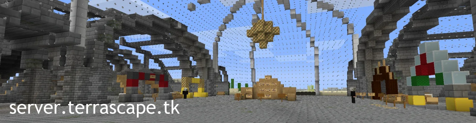 Inside a large stone station with a glass roof and arches, signs and shop stalls along the floor, with server.terrascape.tk written across the bottom